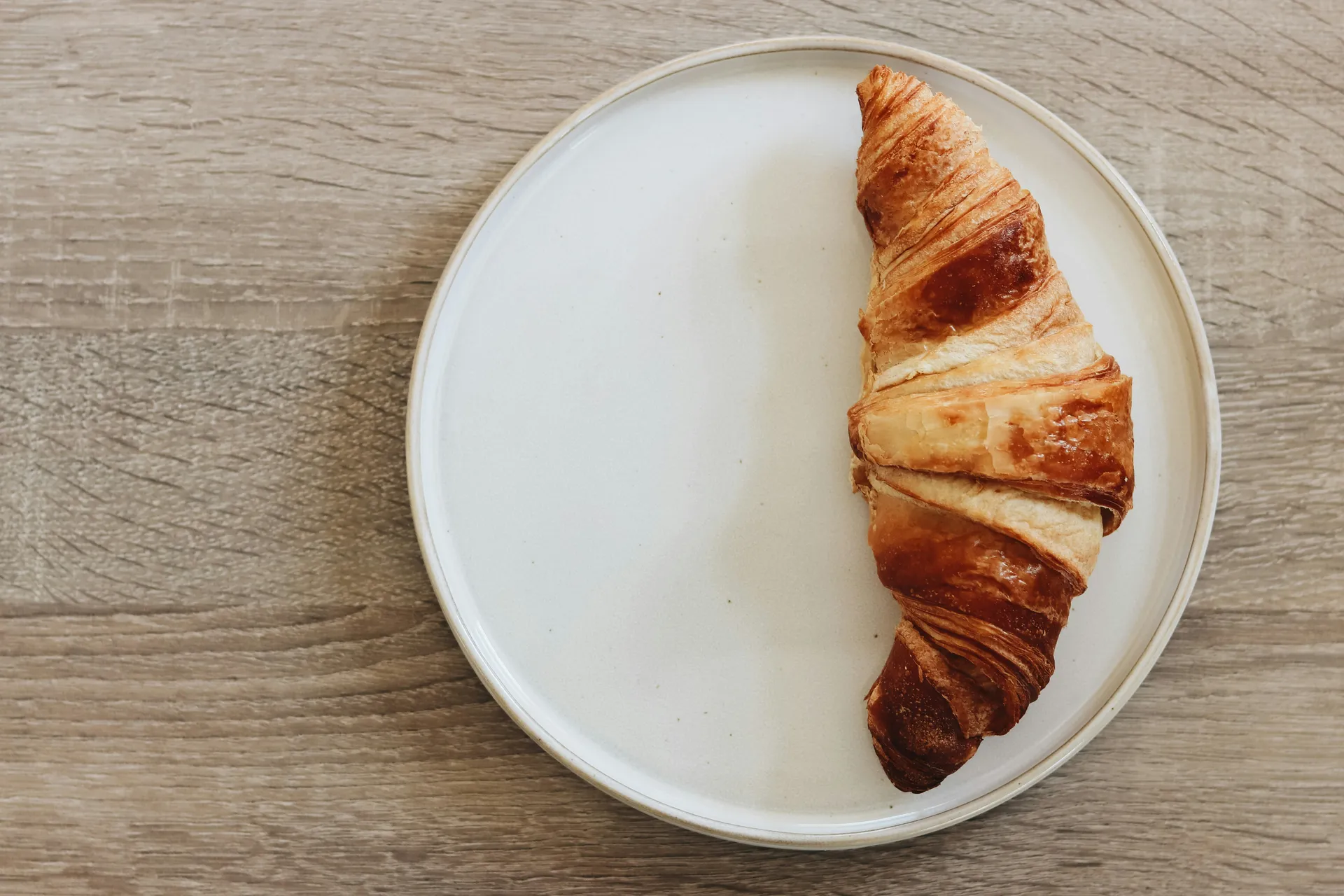Croissant on wooden board
